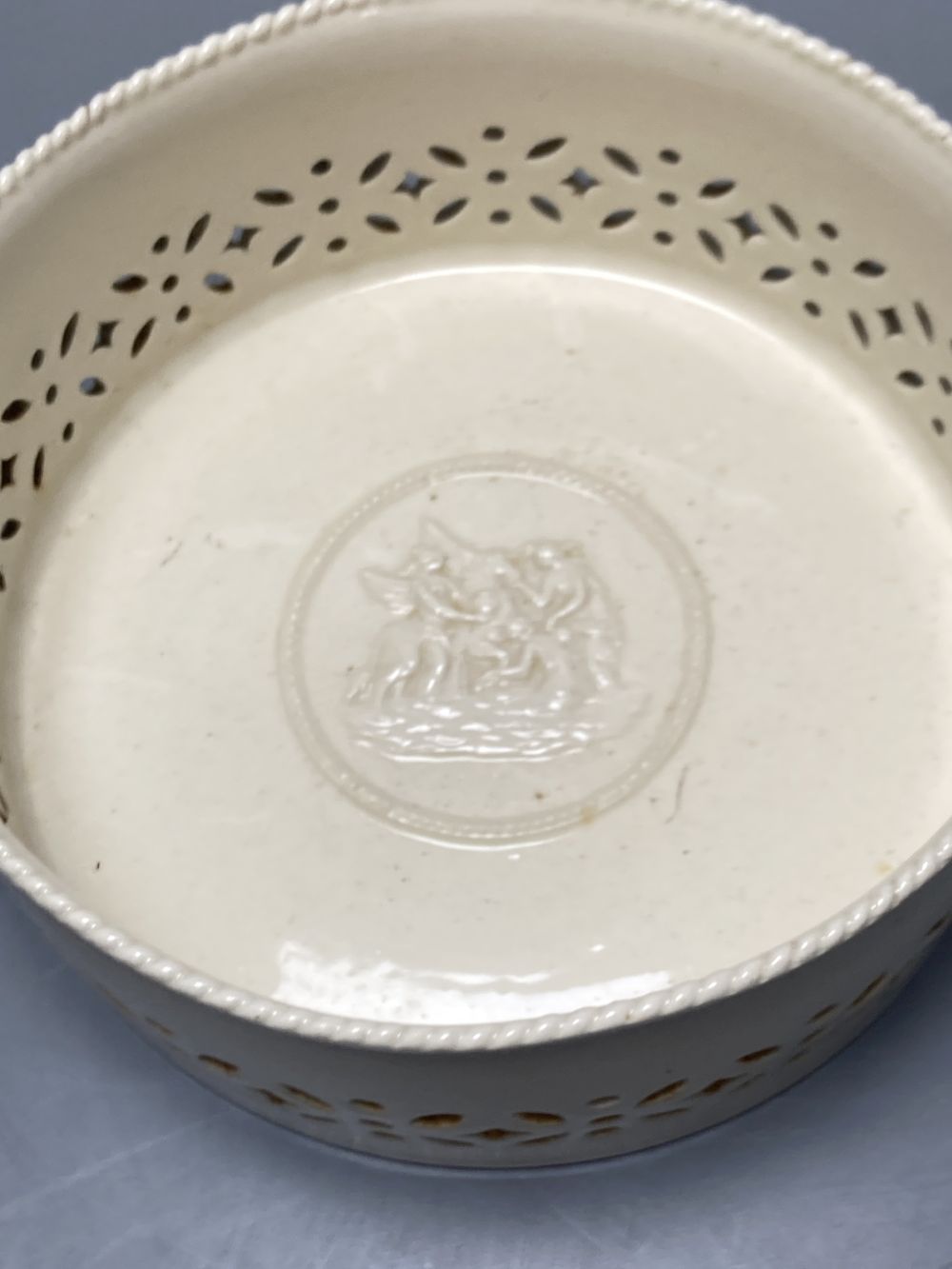 A group of Wedgwood Queensware, 19th century, including ten strawberry plates, a coaster, a jug and six drabware plates